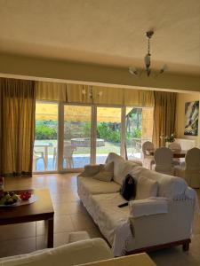 a living room with a white couch and a table at Villa Beauty in Paliouri
