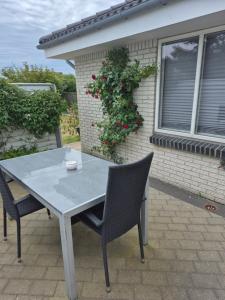 a table and chairs in front of a house at Marias house i Agger in Vestervig +4 photos