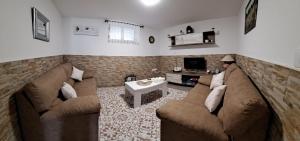 a living room with two couches and a table at MERAKI in Fisterra