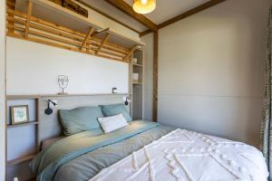 a bedroom with a bed in a room at Camping les vergers de Squividan *** in Tréffiagat +85 photos