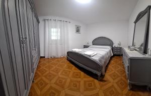 a bedroom with a bed and a vanity and a mirror at MERAKI in Fisterra