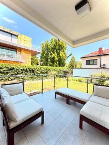 a patio with two couches and a table at Central Townhouse with Parking in Ljubljana