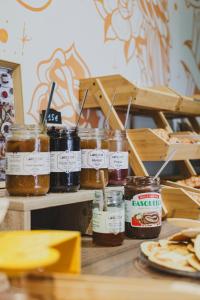 a bunch of jars of honey on a table at Surf Club Hôtel by Akena - Grande plage in Biarritz
