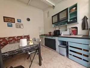 a kitchen with a table and a counter top at Miri's House in Eforie Sud