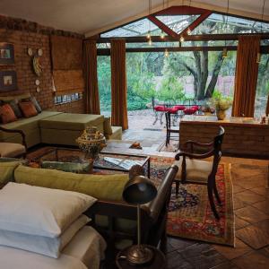 a living room with a couch and a table at Lethabo Estate in Lanseria