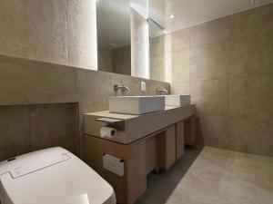 a bathroom with a toilet and a sink and a mirror at SODO Hotel in P'aju +25 photos