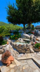 a garden with rocks and plants and a pond at Mountain Escape Villa in Gamvriá
