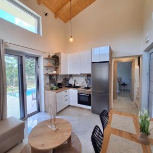 a kitchen with a table and a dining room at Dream Time Villas Vasiliki in Vasiliki