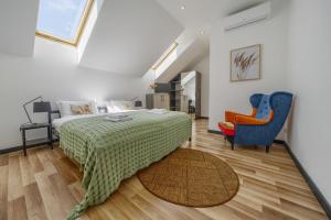 a bedroom with a bed and a couch and a chair at MŁYŃSKA 8 Opole-Górki in Opole