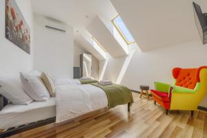 a bedroom with a bed and a yellow chair at MŁYŃSKA 8 Opole-Górki in Opole