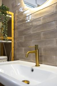 a sink with a gold faucet in a bathroom at Dimitra Beach Apartments - Thassos Skala Potamias in Skala Potamias +100 photos