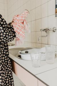 a woman standing in a kitchen with a sink at Camping De Meidoorn in Sluis +14 photos