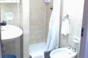 a bathroom with a shower and a sink and a toilet at Hotel Glavjc in Torno