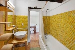 a bathroom with a tub and a sink at La Clé de l'Arboux in Mandagout +32 photos