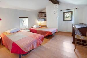 a hotel room with two beds and a piano at La Clé de l'Arboux in Mandagout