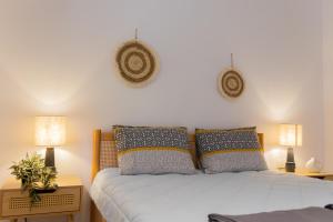 a bedroom with a white bed with two lamps at Dimitra Beach Apartments - Thassos Skala Potamias in Skala Potamias