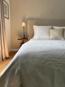 a bedroom with a large bed with white sheets and pillows at Kermaria Studio Suite in Pont-Aven +31 photos