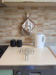 a kitchen counter with a stove with a pot on it at Star Apartment 2- Spacious in the heart of Durres in Durrës