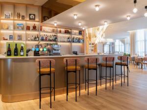 a bar in a restaurant with bar stools at Mercure Tours Nord in Tours