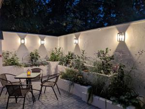 a patio with a table and chairs and plants at Apartament Retro in Paczków