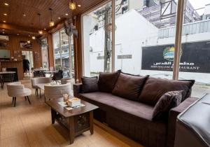 a living room with a couch and a table at Best Inn Hostel and Café Patong Beach in Patong Beach