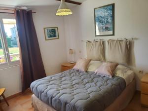 a bedroom with a large bed in front of a window at La Caleche in Bégadan