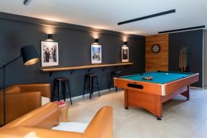 a billiard room with a pool table and a bar at Blacksmith house - SPA, Heated outdoor pool, Kids zone in Varaždinske Toplice +60 photos