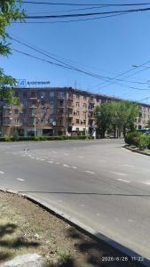 an empty street in front of a large building at Светлый уголок in Yerevan