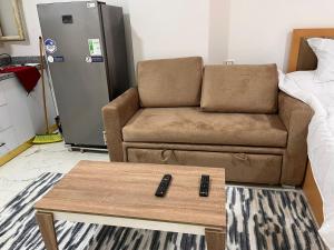 a living room with a couch and a coffee table at Lavanda Beach Resort Studio - Panoramic Sea & Pool View in Abū Rudays