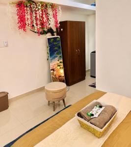 a room with a table and a chair and flowers on the wall at BNBees Anjuna Goa in Chapora