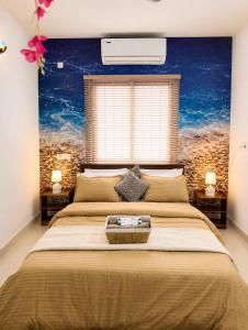 a bedroom with a large bed with a large window at BNBees Anjuna Goa in Chapora