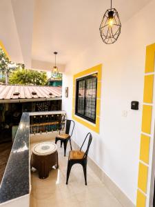 a tasting room with two chairs and a table at BNBees Anjuna Goa in Chapora