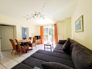 a living room with a couch and a table at Ferienhof Peter in Vollerwiek