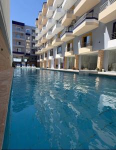 an empty swimming pool in front of a building at Lavanda Beach Resort Studio - Panoramic Sea & Pool View in Abū Rudays