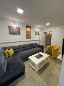 a living room with a couch and a table at Apartman Teodora in Risan