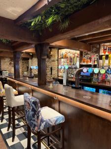 a bar with two chairs sitting at a counter at The Manor House Hotel in Dronfield