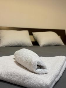 a pile of towels sitting on top of a bed at Apartman Teodora in Risan