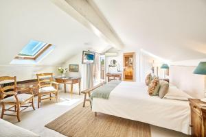 a bedroom with a bed and a table and chairs at La Ferme D'Augustin in Saint-Tropez