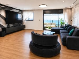 a living room with a couch and a chair and a television at דירת החלומות באשדוד in Ashdod