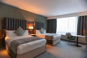 a hotel room with two beds and a desk at Pillo Hotel & Leisure Club in Ashbourne +27 photos