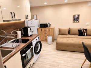 a kitchen and living room with a couch at Apartment Underground, Premium Apartment in Ruse City Centre in Ruse