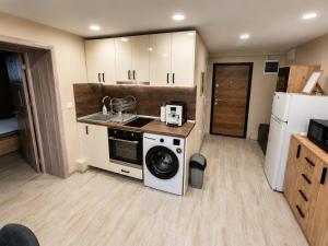 a kitchen with a washing machine and a washer at Apartment Underground, Premium Apartment in Ruse City Centre in Ruse +37 photos