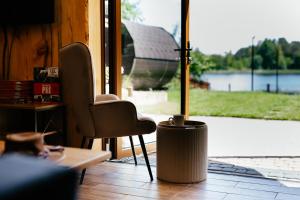 a room with a chair and a table and a window at Augustów Willa Sóweczka in Sucha Rzeczka