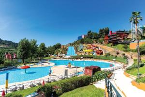 a large pool in a amusement park with a roller coaster at Moradia Vila Golfe in Amarante