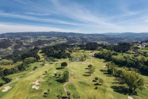 an aerial view of a golf course with mountains in the background at Moradia Vila Golfe in Amarante
