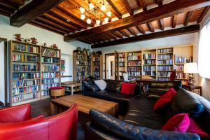 a living room with couches and bookshelves at B&B Villa Cardeto in Anghiari +29 photos