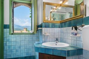 a bathroom with a sink and a mirror at Case Saponara in Cefalù +28 photos