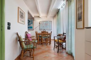 a dining room with chairs and a table at Case Saponara in Cefalù