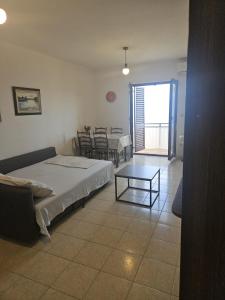 a bedroom with a bed and a table in it at See view Apartment 2 in Mimice