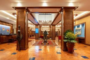 a lobby with a statue in the center of a building at Nairobi Serena Hotel in Nairobi +101 photos